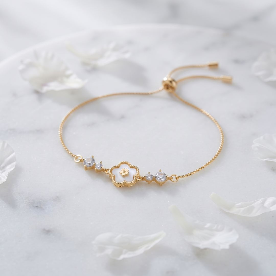 Blanche Clover Bracelet on white marble with peony petals