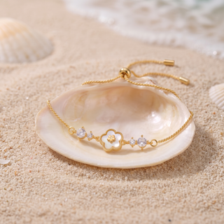 Blanche Clover Bracelet on a seashell on sand