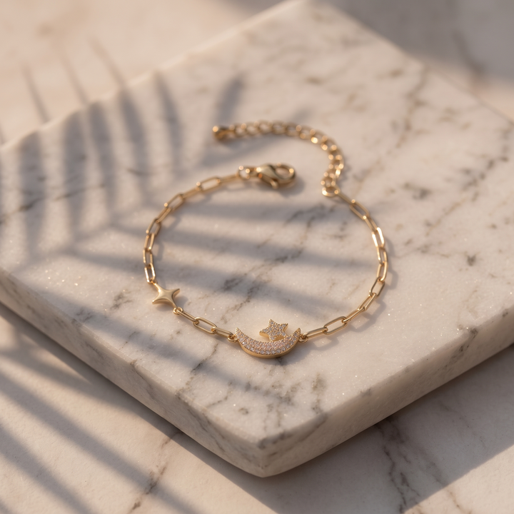 Céleste Moon & Star Bracelet on marble in sunlight