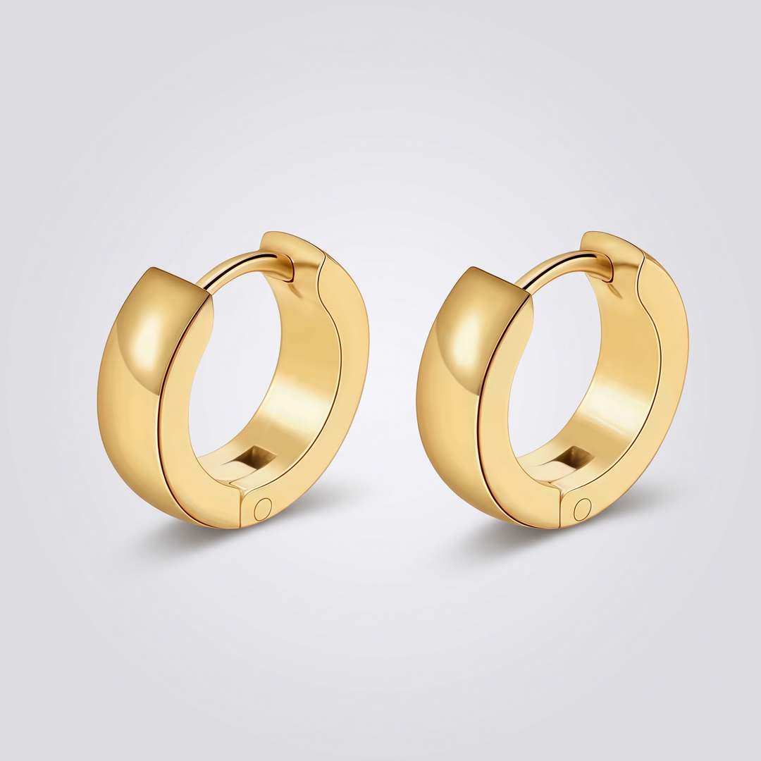 Chunky Huggie Hoops – pair of gold-tone wide-band huggie hoop earrings, front view on grey studio background
