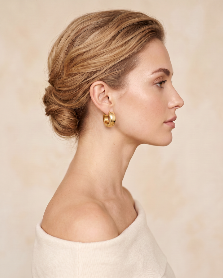Chunky Huggie Hoops – gold-tone chunky huggie hoop worn on a model with an updo, side profile