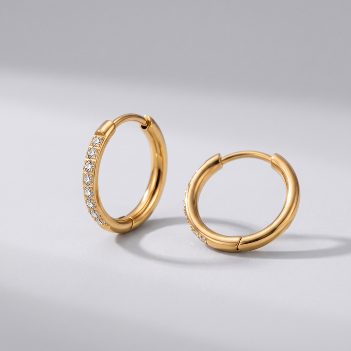 Crystal Huggies in gold-tone, angled view of the pair with hinged hoop