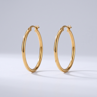 Everyday Hoops: pair of thin plain round gold-tone hoop earrings, front view on grey studio background