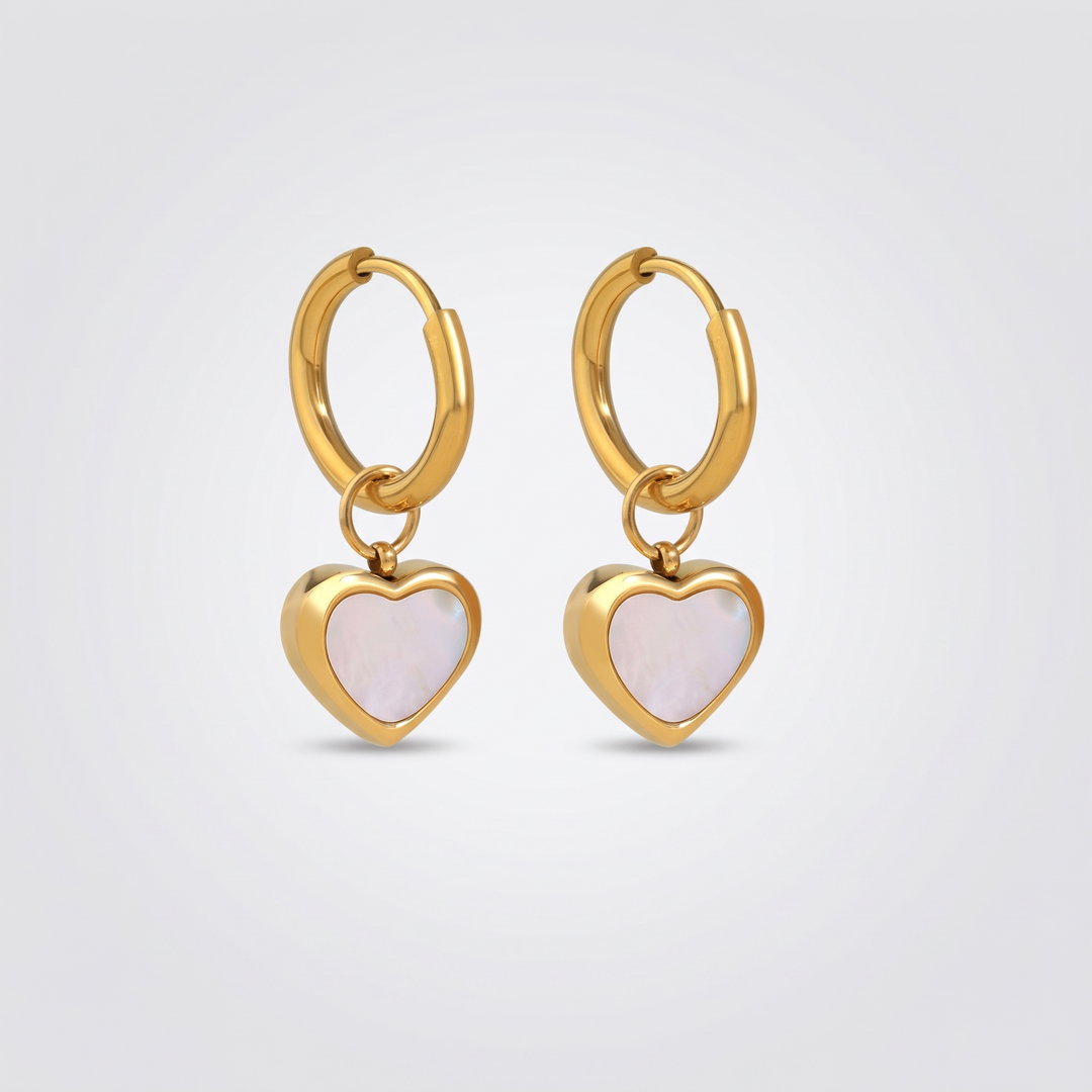 Heart Huggies - pair of small gold-tone huggie hoop earrings with white shell heart charms, front view