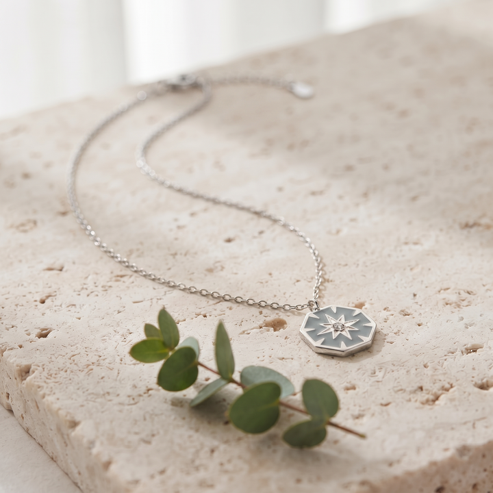 North Star Pendant Necklace in silver on travertine with eucalyptus