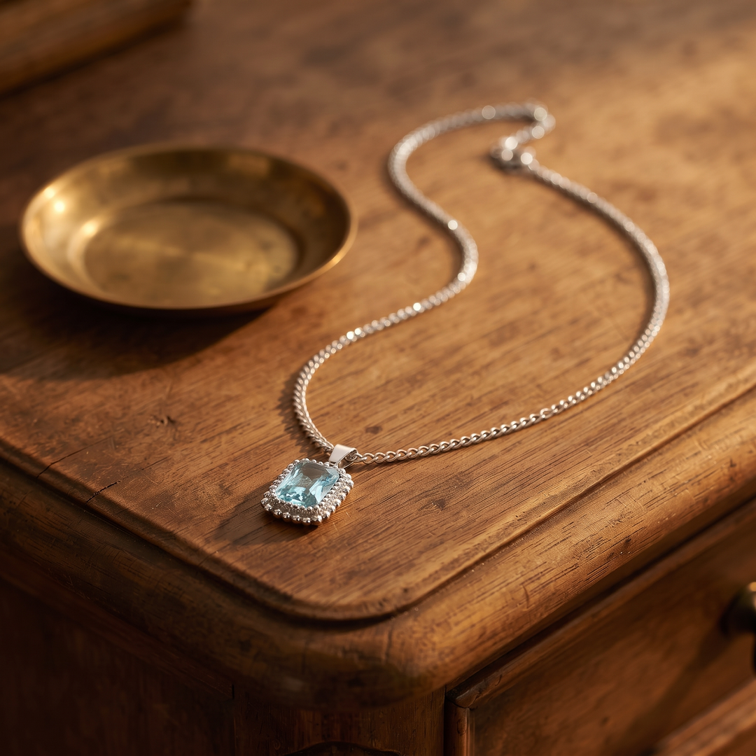 Vintage Gemstone Pendant Necklace, silver with aquamarine, on an antique dresser