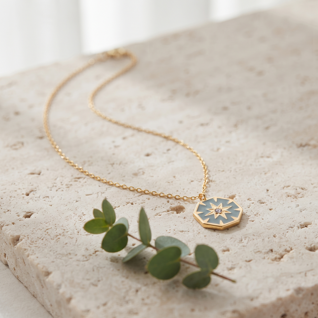North Star Pendant Necklace on travertine with eucalyptus
