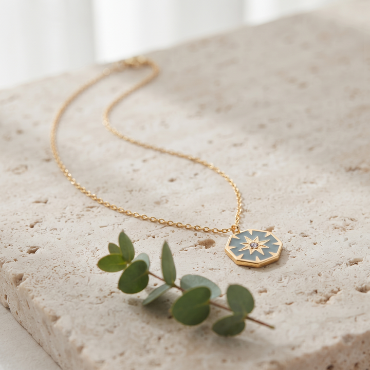 North Star Pendant Necklace on travertine with eucalyptus