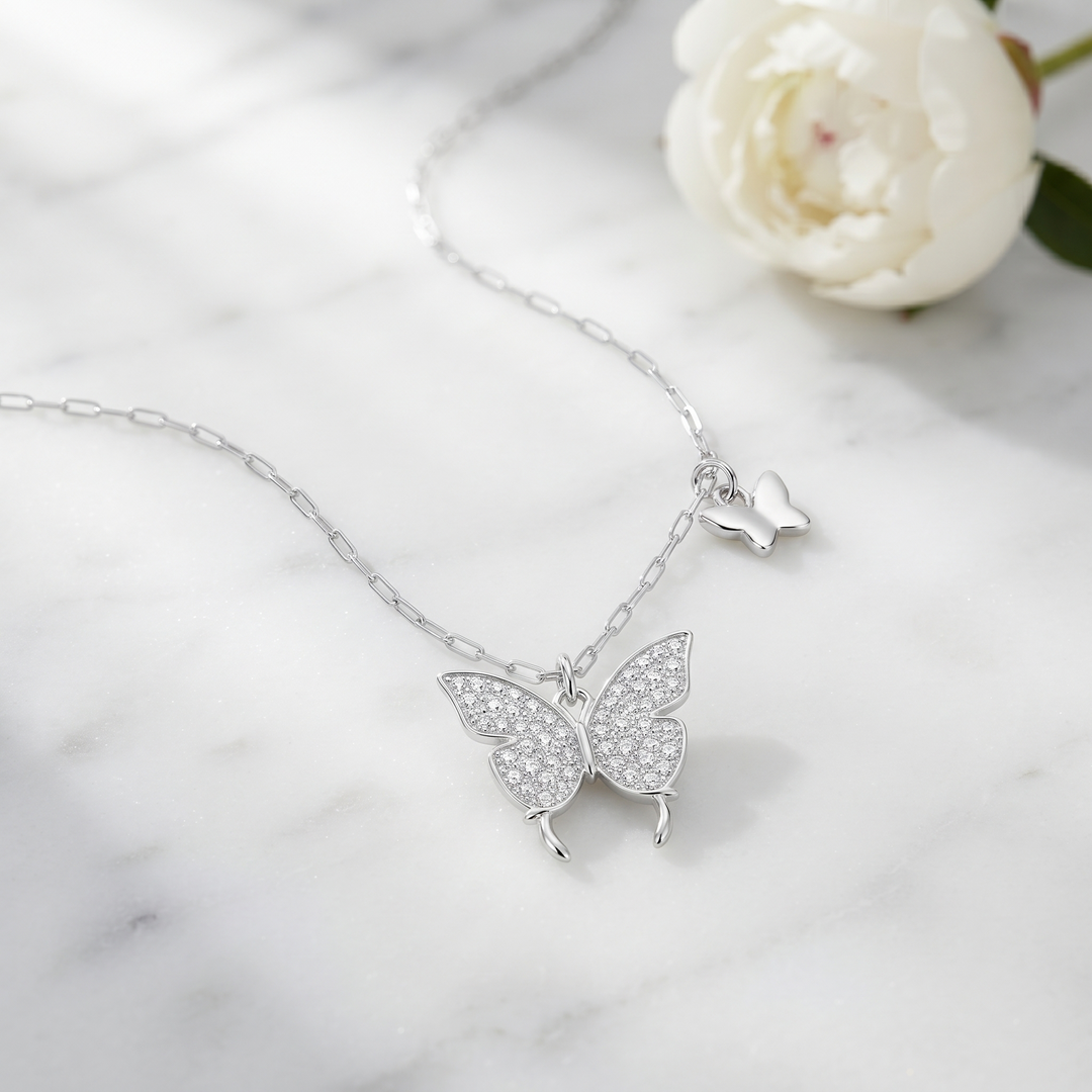 Butteréa Crystal Necklace on white marble with a peony