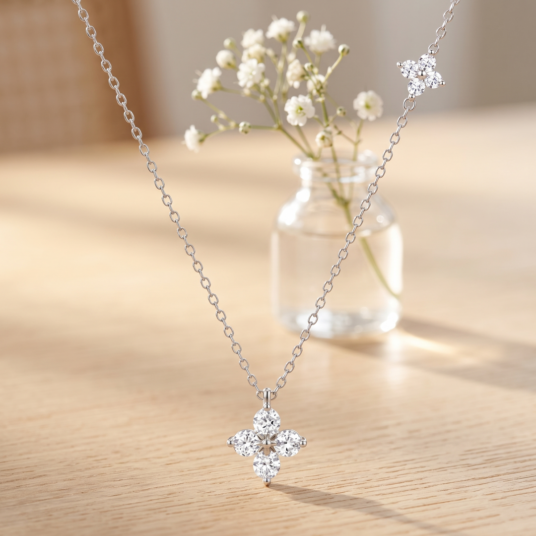Éclat Fleur Necklace on an oak table with gypsophila