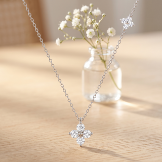Éclat Fleur Necklace on an oak table with gypsophila