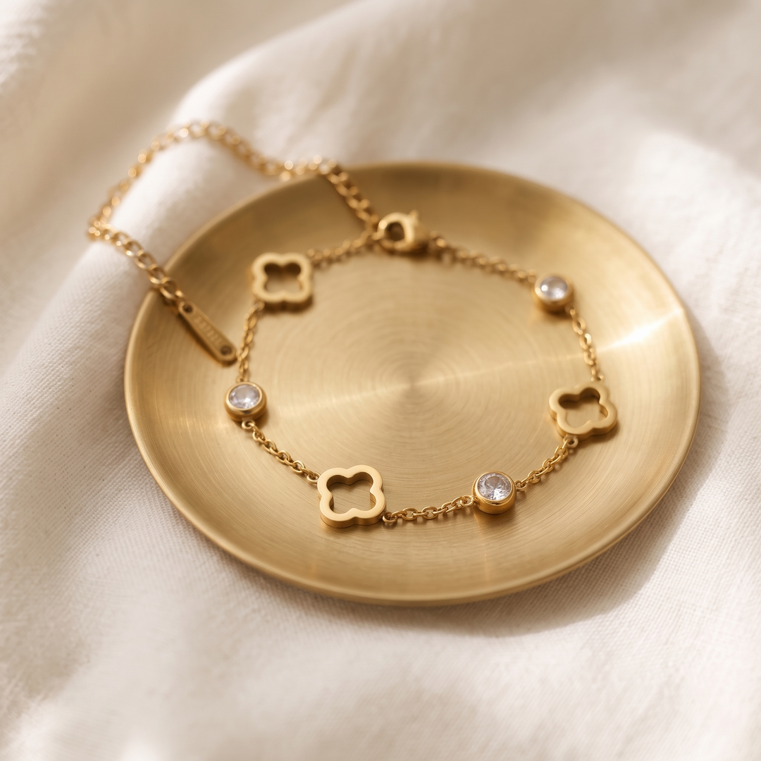 Lumière Clover Bracelet on a gold dish on cream linen