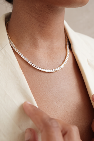 Model wearing the Classic Tennis Necklace at the collarbone with a beige blazer