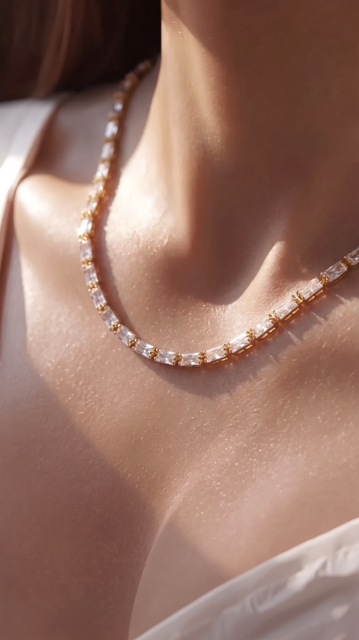 Close-up of the Classic Tennis Necklace worn around the neck in sunlight