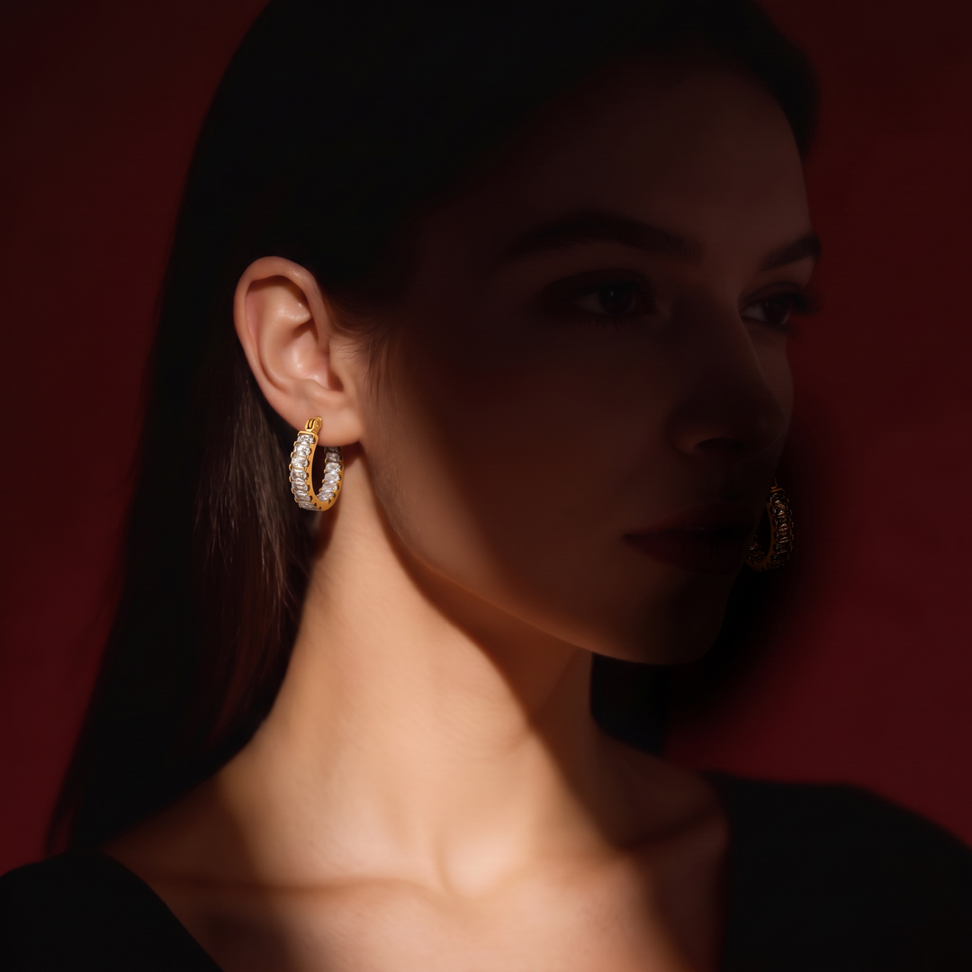 Model wearing the gold-tone Tennis Huggie Hoops, close to the earlobe