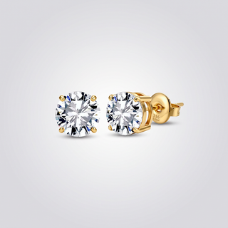 Classic Solitaire Studs in gold-tone, pair of 4-prong round clear zirconia stud earrings on grey studio background