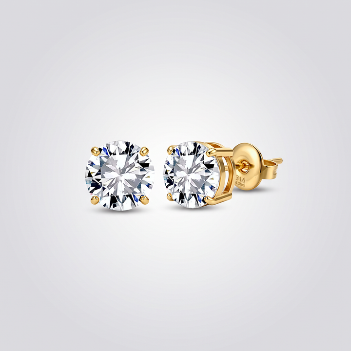 Classic Solitaire Studs in gold-tone, pair of 4-prong round clear zirconia stud earrings on grey studio background