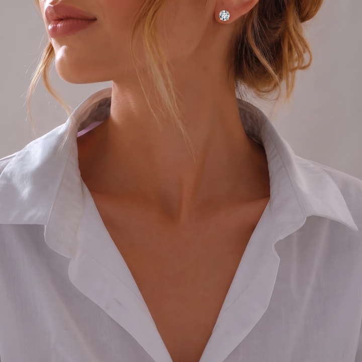 Model in white shirt wearing a Classic Solitaire Stud in gold-tone