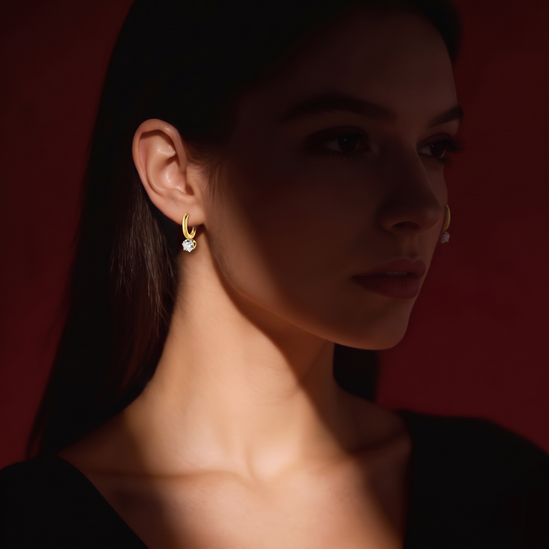 Mini Crystal Huggies worn on a model, dark red background