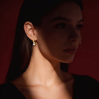 Mini Crystal Huggies worn on a model, dark red background