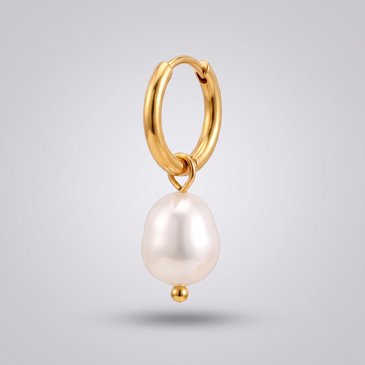 Pearl Drop Huggies in gold: close-up detail of the freshwater pearl and its jump ring on the hoop