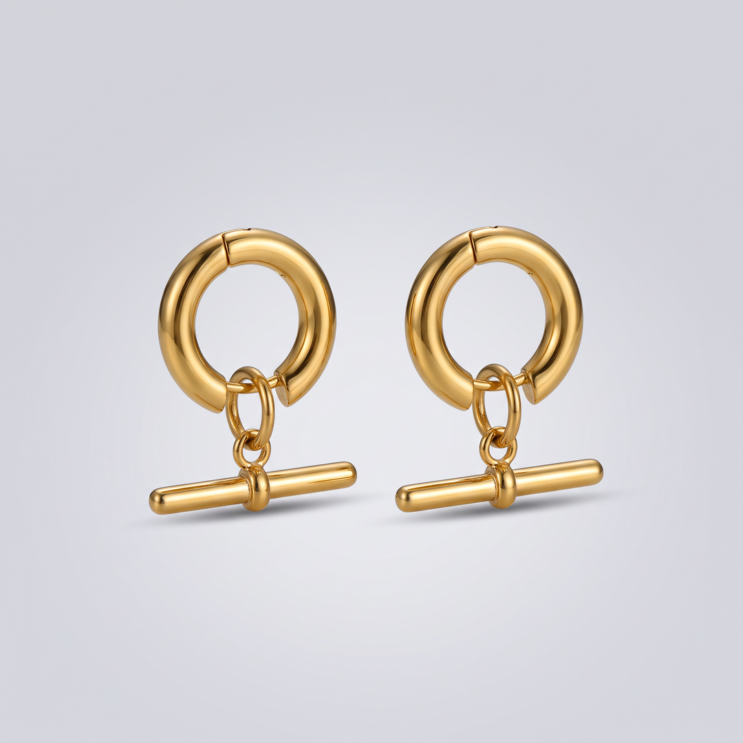 Moshié T-Bar Hoops in gold-tone, angled flat-lay view of the pair