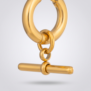 Close-up of the polished T-bar and connector ring on a gold-tone T-Bar Hoop earring