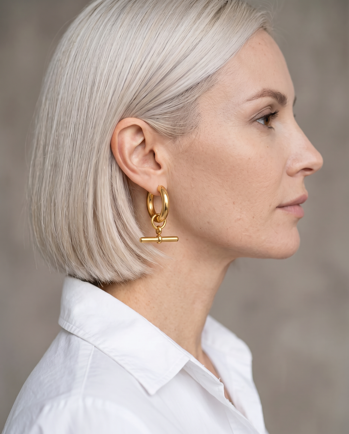Model with platinum bob wearing a gold-tone T-Bar Hoop earring, side profile